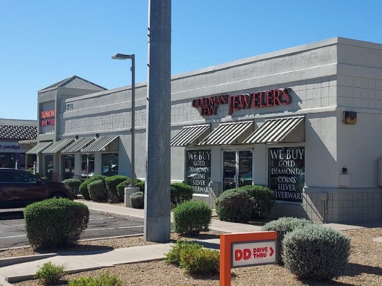 A plain retail store painting job on a grey exterior building with a drive-thru sign in front