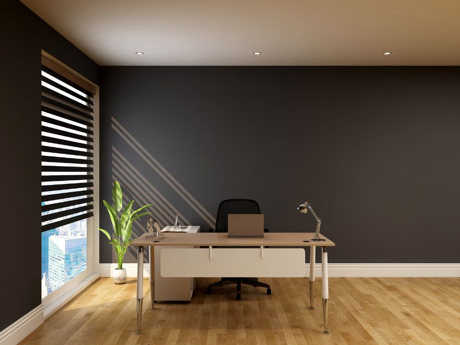 Modern office with dark walls and colors that increase productivity, wood floors, sleek desk setup