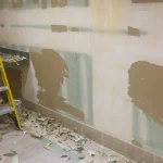 Ongoing drywall repair and repainting in progress.
