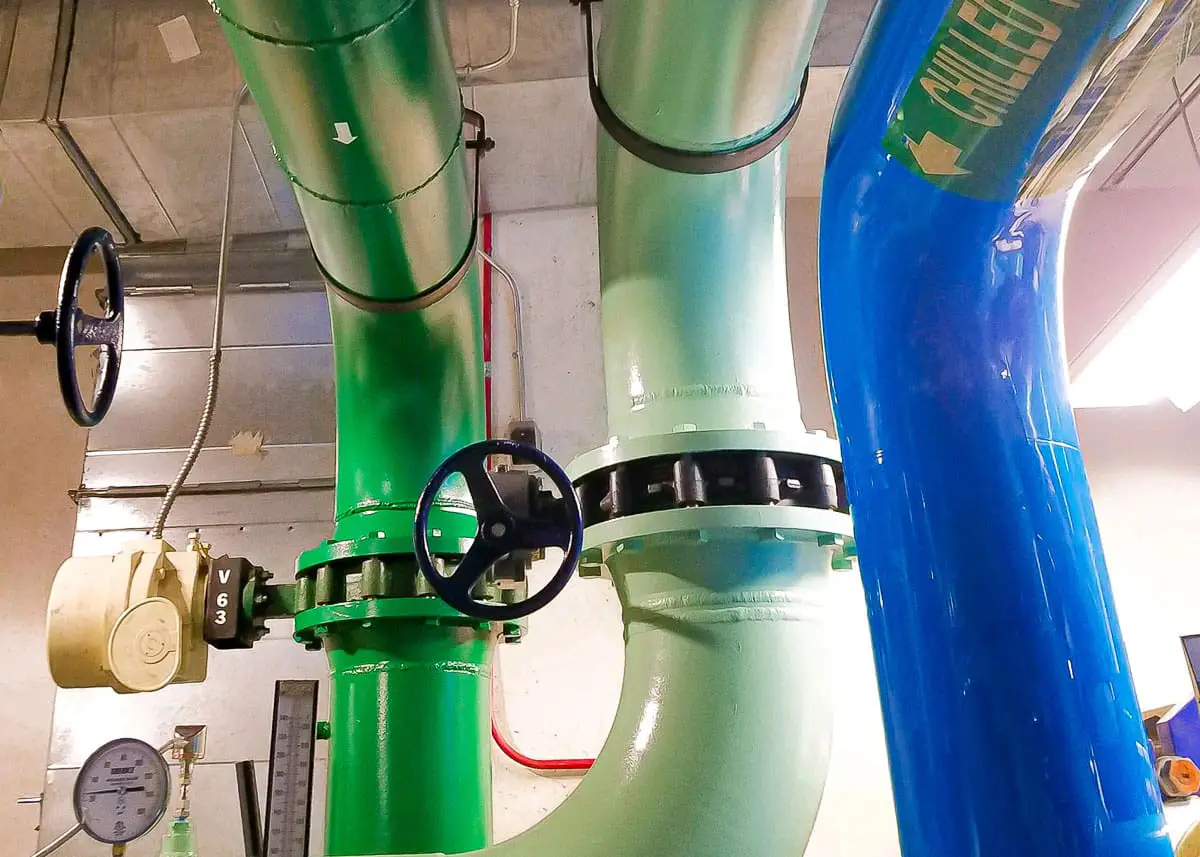 Industrial pipes freshly painted in a sleek, uniform color, standing out against a clean background.