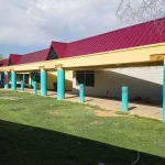 Exterior view of a building with freshly applied paint, showcasing a modern color scheme that highlights architectural details.