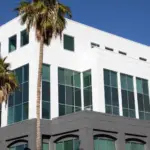 A building featuring expansive glass windows, blending modern architecture with transparency and natural light.