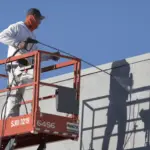 Guy holding a Commercial Paint Sprayer