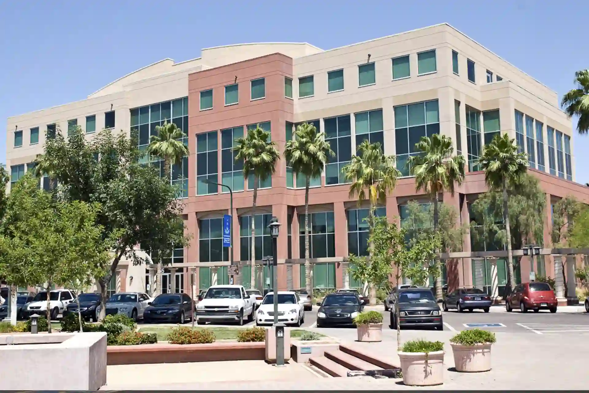 Commercial building w/ cars parked in front of the building