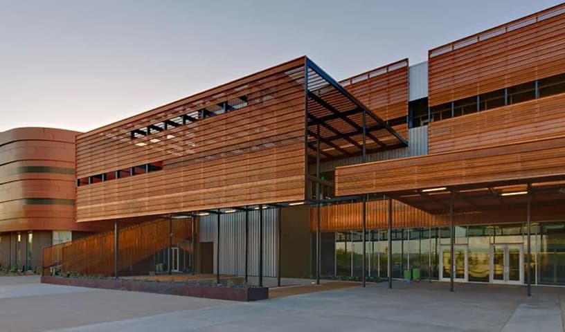 Contemporary campus building featuring wood paneling and glass façade