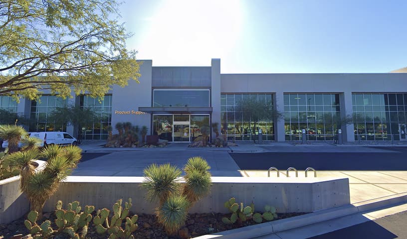 Commercial building exterior with glass façade and desert landscaping