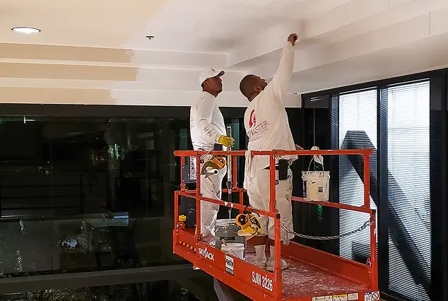 Commercial interior painting crew painting ceiling