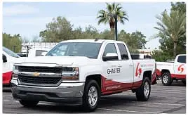 Ghaster Painting company truck with logo at exterior painting project