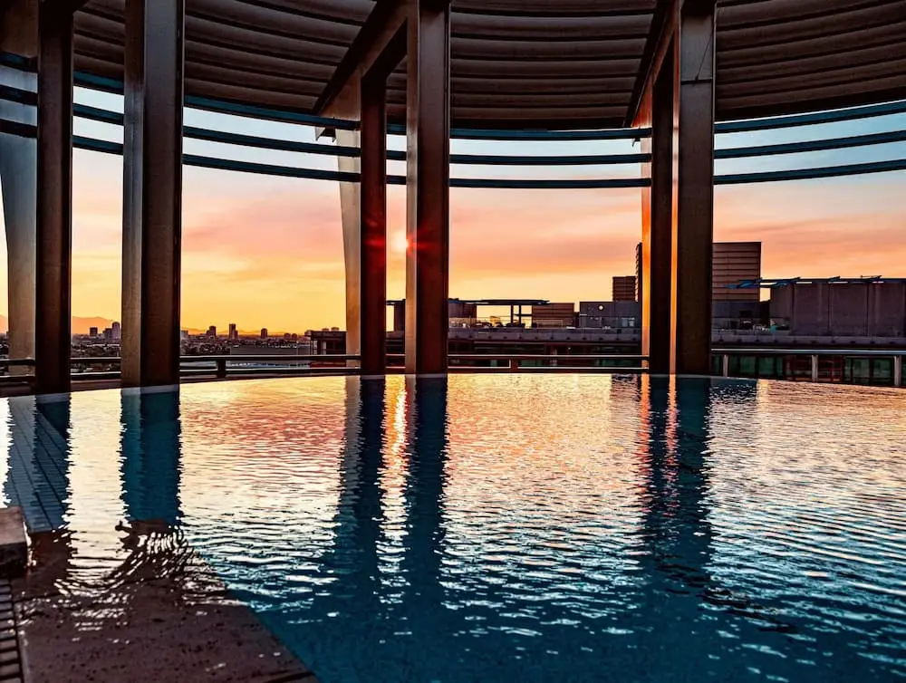 Rooftop swimming pool with professional pool coating and city skyline