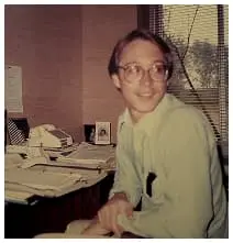 Vintage office scene showing Ghaster working at desk