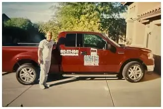 Ghaster Painting & Coatings team member standing next to branded company truck