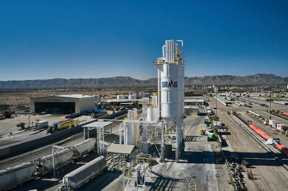 Exterior view of an industrial plant with storage tanks and processing towers