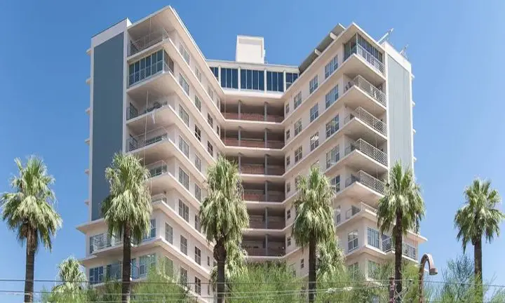 Exterior painting of multi-story residential building with balconies