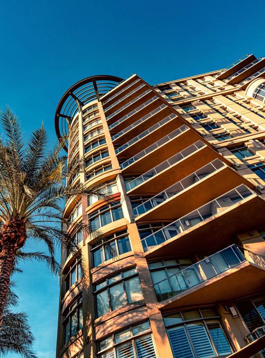 Professional exterior painting on multi-story apartment building