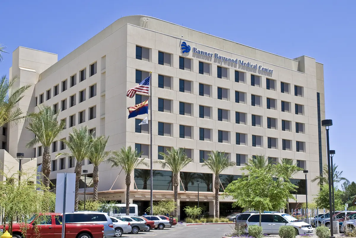 Medical center hospital exterior facade with parked cars